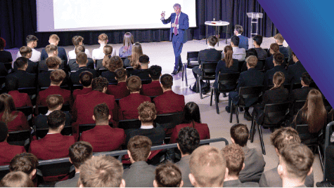 Davide Dean delivering inspirational talk to students assembly