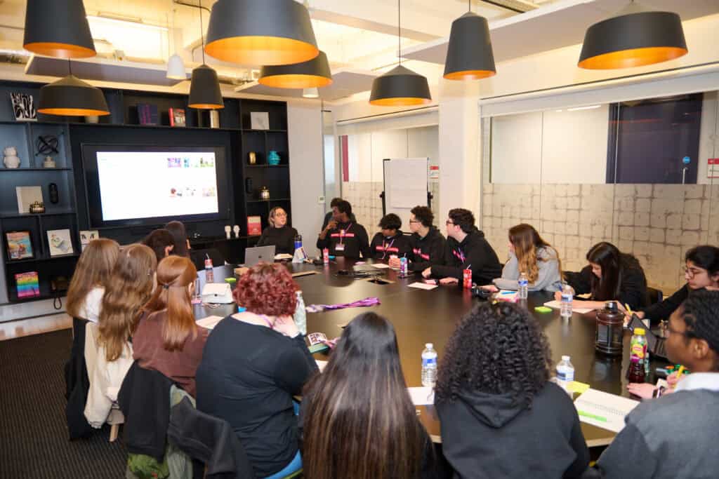 Group of diverse young people engaged in a discussion, representing the Speakers for Schools Youth Council.